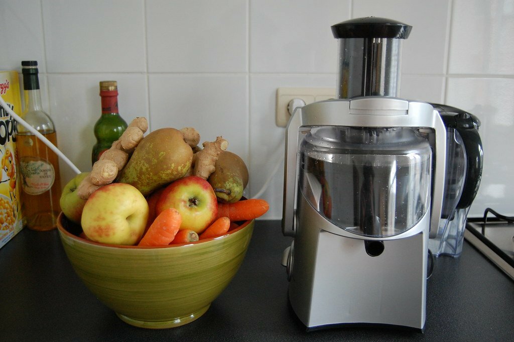juicer with fruits on the side